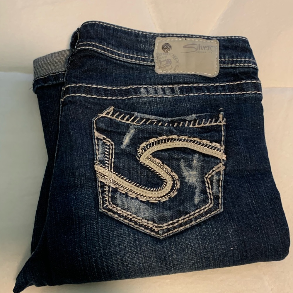 Distressed boot cut silver jeans